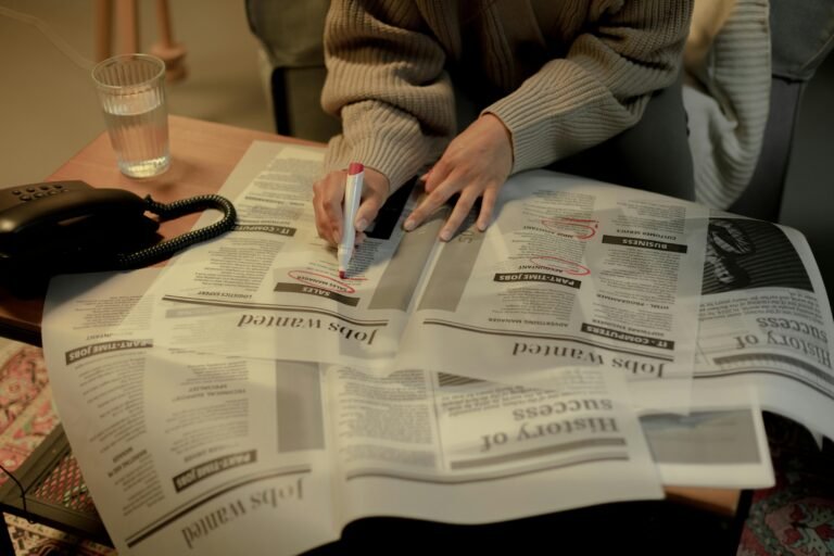 CPA looking through newspapers for a new job at IPG Workforce Solutions