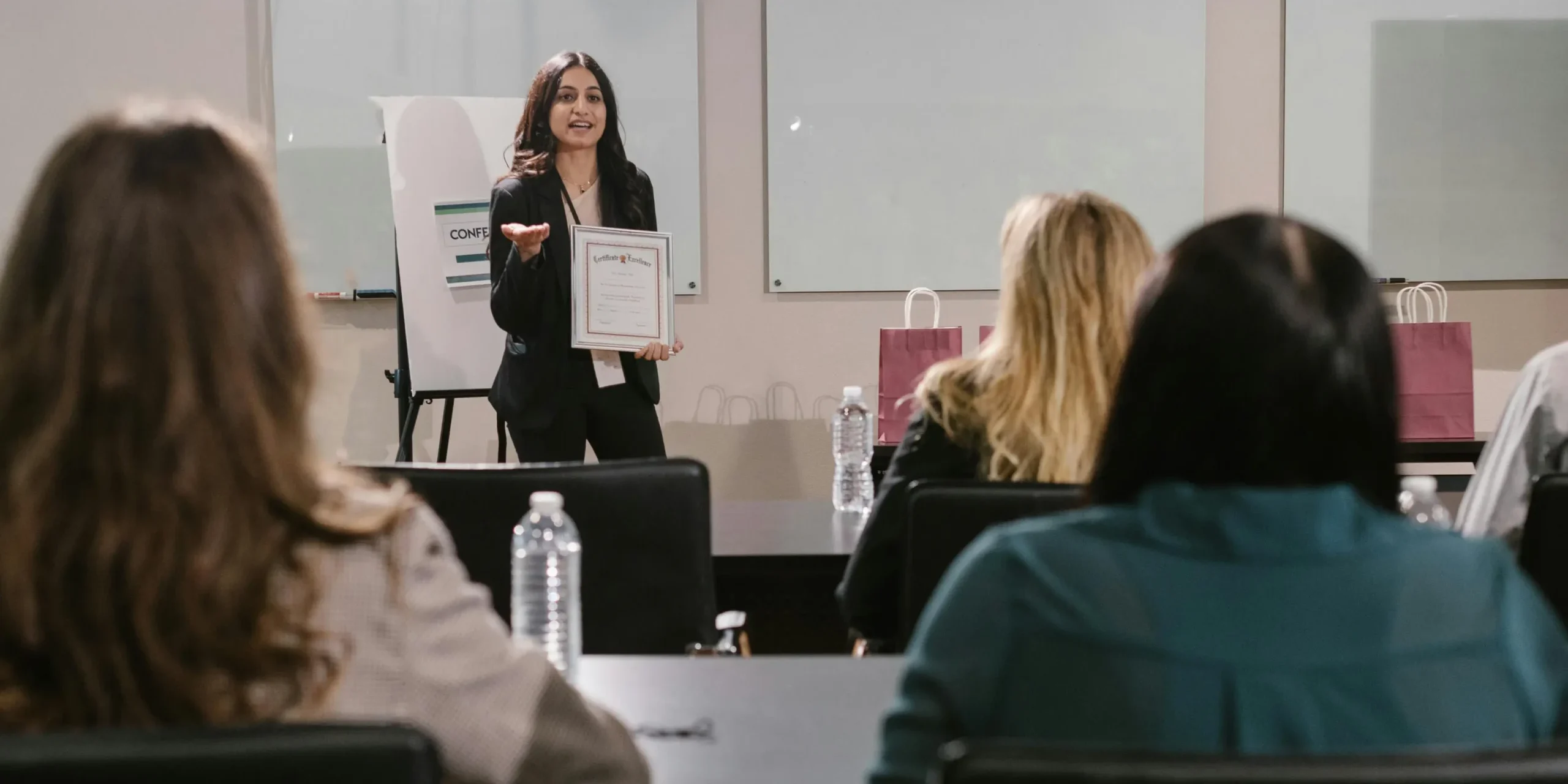 Finance professional receiving certification during a career development seminar.