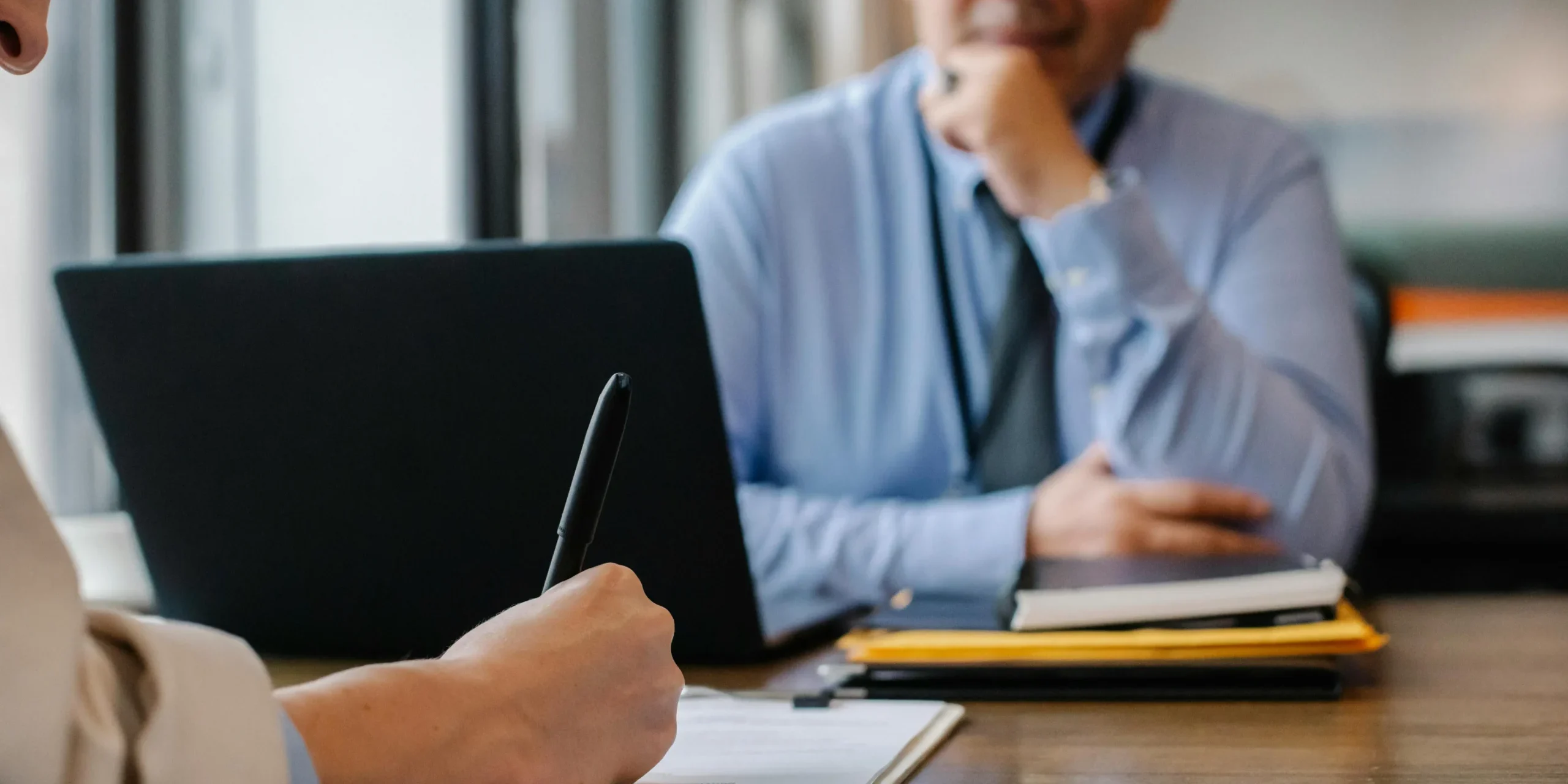 Employer reviewing recruitment checklist and notes for finance and accounting hiring.