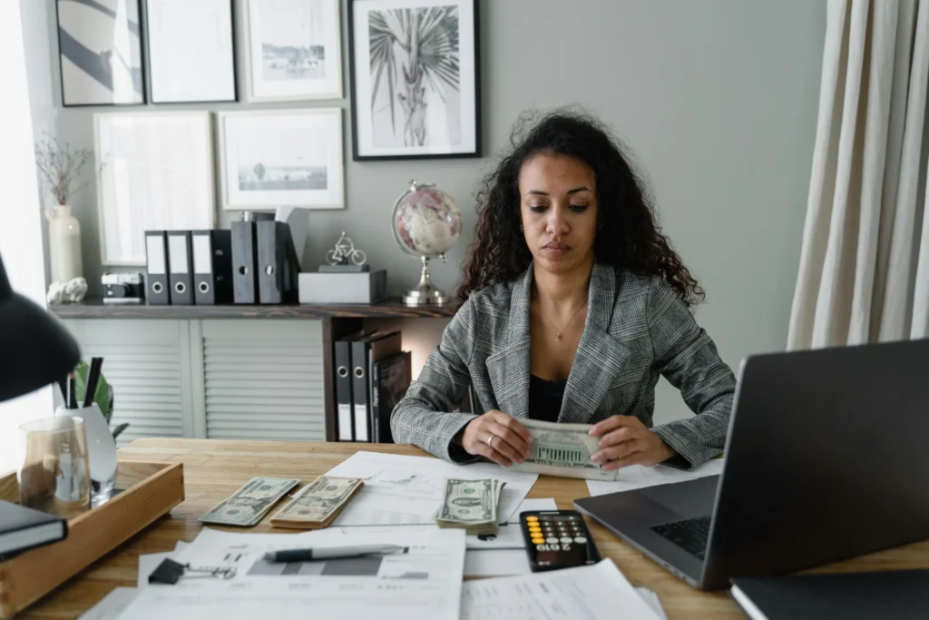 Accountant reviewing financial documents and cash flow at a small CPA firm office