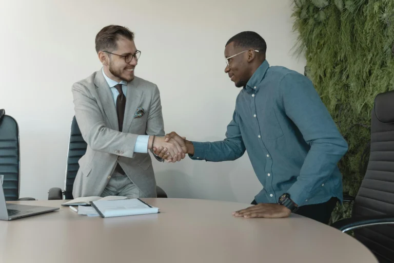 Client meeting with accounts payable staffing agency consultant shaking hands